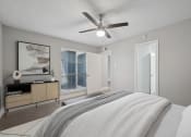 Thumbnail 7 of 41 - a bedroom with a large bed and a ceiling fan