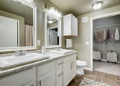 Thumbnail 12 of 33 - a bathroom with two sinks and a toilet and a mirror