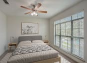 Thumbnail 7 of 52 - a bedroom with a bed and a ceiling fan