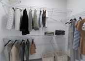 Thumbnail 9 of 44 - a closet with a rack of clothes hanging on the wall