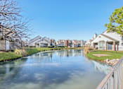 Thumbnail 15 of 15 - A serene residential area with a canal running through it.