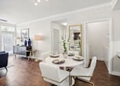 Thumbnail 12 of 33 - a living room and dining room with a table and chairs
