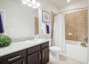 Thumbnail 21 of 33 - a bathroom with a sink and a toilet and a shower