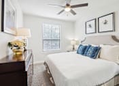 Thumbnail 19 of 33 - a bedroom with a large bed and a ceiling fan