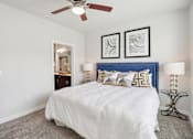 Thumbnail 15 of 33 - a bedroom with a large bed and a ceiling fan