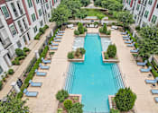 Thumbnail 3 of 33 - an aerial view of a swimming pool in front of a building