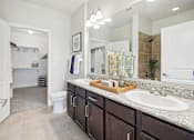 Thumbnail 17 of 33 - a bathroom with a sink and a toilet and a mirror