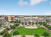Thumbnail 5 of 33 - an aerial view of a campus with buildings and a green field