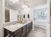 Thumbnail 16 of 33 - a bathroom with a sink and a mirror