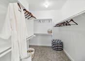 Thumbnail 18 of 33 - a white closet with a white robe and a stool