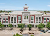 Thumbnail 4 of 33 - an aerial view of a building with a clock tower