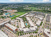 Thumbnail 32 of 33 - an aerial view of a city with buildings and a pool