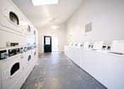 Thumbnail 78 of 79 - a washer and dryer room with a row of washes and dryers