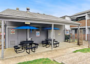 Thumbnail 59 of 79 - a patio with tables and umbrellas outside of a house