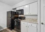Thumbnail 11 of 79 - a kitchen with white cabinets and a black stove and refrigerator