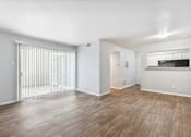 Thumbnail 14 of 79 - the living room of an apartment with a large window and wood flooring