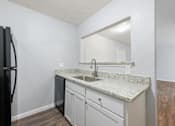 Thumbnail 24 of 79 - a kitchen with white cabinets and a counter top with a sink