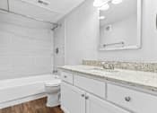 Thumbnail 29 of 79 - a bathroom with a sink and a toilet and a tub