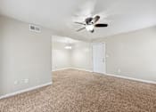 Thumbnail 27 of 79 - the spacious living room with ceiling fan and carpet