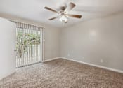 Thumbnail 34 of 79 - an empty living room with a ceiling fan and a window