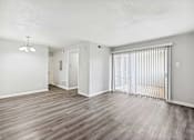 Thumbnail 5 of 79 - an empty living room with a sliding glass door to a balcony