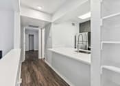 Thumbnail 3 of 79 - a white kitchen with a sink and a refrigerator