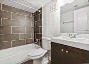 Thumbnail 9 of 79 - a bathroom with a toilet and a tub and a sink