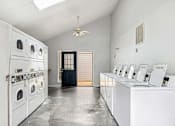 Thumbnail 57 of 79 - a white laundry room with washers and dryers