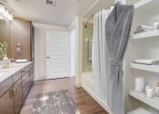 Thumbnail 9 of 44 - a bathroom with a shower and a sink and a rug