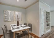 Thumbnail 3 of 52 - a dining room with a table and chairs and a door to a closet