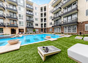 Thumbnail 15 of 31 - an apartment building with a pool in the middle of it