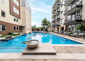 Thumbnail 16 of 31 - a swimming pool in front of an apartment building