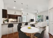 Thumbnail 3 of 28 - a kitchen and dining room with a white table and chairs