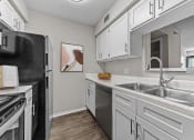 Thumbnail 5 of 29 - a kitchen with stainless steel appliances and white cabinets