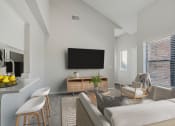 Thumbnail 2 of 28 - a living room with a couch and a table and a television