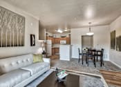 Thumbnail 3 of 22 - A modern living room with a white couch and a coffee table.
