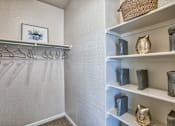 Thumbnail 8 of 22 - A white closet with a shelf and a picture of a plant.