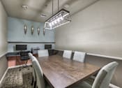 Thumbnail 14 of 22 - A conference room with a long table and chairs.
