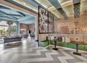 Thumbnail 26 of 35 - a lobby with a brick wall and wood flooring