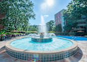 Thumbnail 37 of 45 - a fountain in the middle of a courtyard with a building in the background