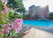 Thumbnail 39 of 45 - a swimming pool with a fountain and a bench in front of a building