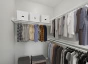 Thumbnail 7 of 28 - a walk in closet with racks of clothes and boxes on the shelves