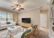 Thumbnail 1 of 42 - a living room with a ceiling fan and a television