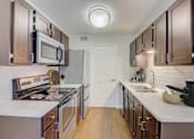 Thumbnail 5 of 33 - a kitchen with stainless steel appliances and white counter tops
