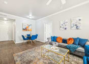 Thumbnail 3 of 53 - a living room with blue couches and a glass coffee table