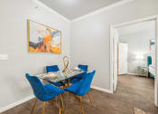 Thumbnail 7 of 53 - a dining room with a glass table and blue chairs