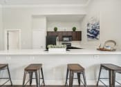 Thumbnail 25 of 53 - a kitchen with bar stools and a counter top with stools