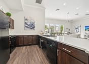 Thumbnail 23 of 53 - a large kitchen with wooden cabinets and a white counter top