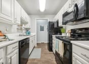 Thumbnail 4 of 53 - a kitchen with white cabinetry and black appliances