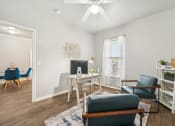 Thumbnail 8 of 53 - a living room with white walls and a table and chairs